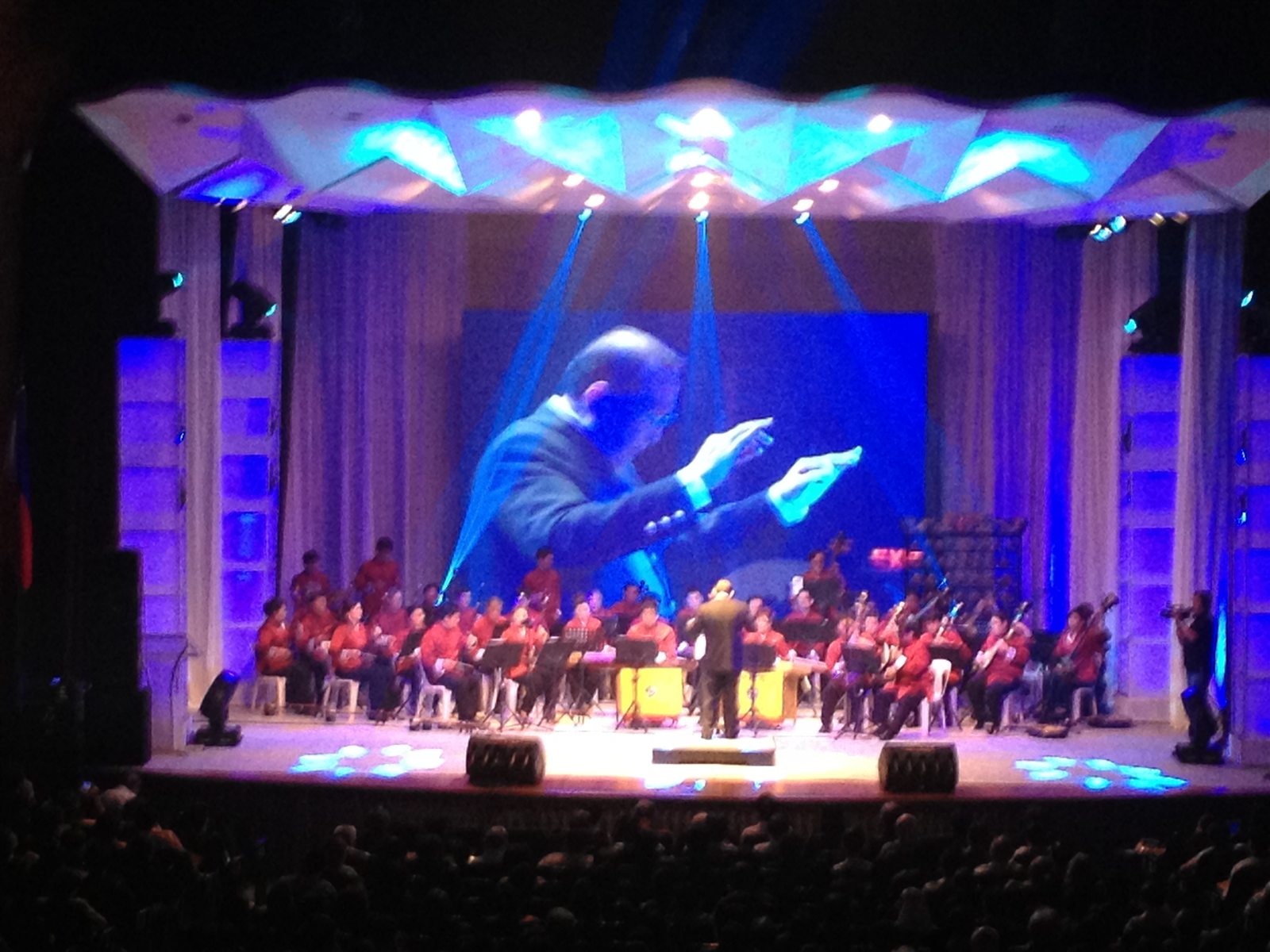 Stage production combining live orchestra and projected performance imagery